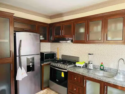 a kitchen with a stainless steel refrigerator and a sink at Apt 2 Bedrooms a Pasos del Malecon y la Playa in San Felipe de Puerto Plata