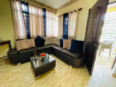 a living room with a couch and a table at Apt 2 Bedrooms a Pasos del Malecon y la Playa in San Felipe de Puerto Plata