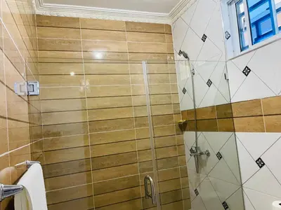 a bathroom with a shower with a glass door at impecable 2 Bedroom Apartment Steps from the Pier in San Felipe de Puerto Plata