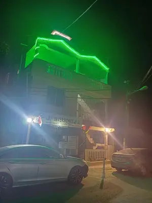 a car parked in front of a gas station at night at Dona Beba Guesthouse in La Caleta