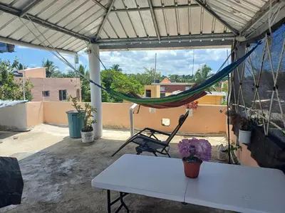 a tent with a hammock on a patio at Dona Beba Guesthouse in La Caleta