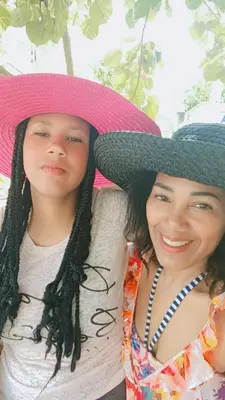 a woman and a young girl wearing a pink hat at las taranas villa tropical