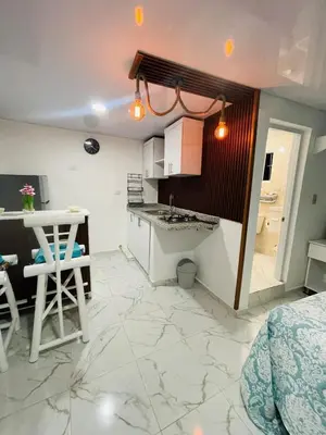 a kitchen with a sink and a table and a counter at Sabor Latino Apartment in San Felipe de Puerto Plata