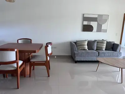 a living room with a couch and a table and chairs at jardines de caleta in La Romana