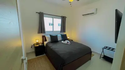 a small bedroom with a bed with a window at Apartamento Armonía-K-204 in Las Terrenas