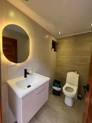 a bathroom with a sink and a toilet and a mirror at Villa refugio de paz in Bayaguana