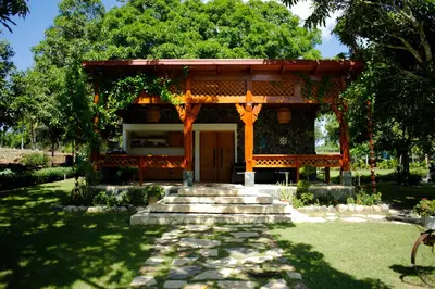 a small building with a gate in a garden at Villa refugio de paz in Bayaguana