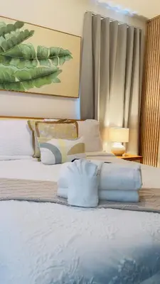 a bedroom with a bed with white sheets and pillows at Coral Blue Apartment- Dominicus in La Laguna