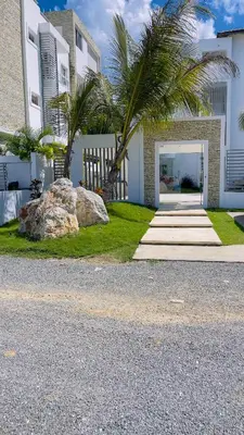 a house with a palm tree and a rock at Coral Blue Apartment- Dominicus in La Laguna