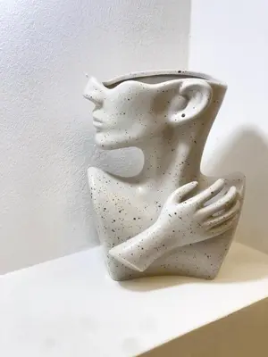 a white vase sitting on top of a shelf at Encanto - La Romana near Caleta beach in La Romana