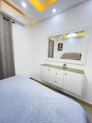 a bedroom with a bed and a large mirror at Encanto - La Romana near Caleta beach in La Romana