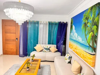 a living room with a painting on the wall at Exclusive Huge and Lovely 4 bedrooms and 3 bathrooms apartments in Santiago close to all funs in Santiago de los Caballeros