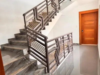 a staircase in a house with a wooden door at Exclusive Huge and Lovely 4 bedrooms and 3 bathrooms apartments in Santiago close to all funs in Santiago de los Caballeros