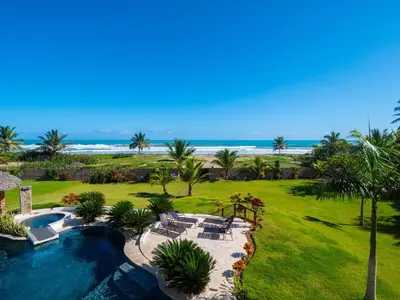 a resort with a swimming pool and the beach at Villa Emoción Del Mar - Beachfront Luxury Villa