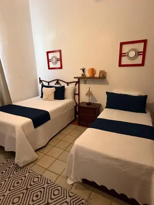 two beds sitting in a room with at Hotel Montesilva in Puerto Plata