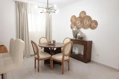 a dining room with a table and chairs at Rustic Charm, Apartment in the heart of Santiago in Santiago de los Caballeros