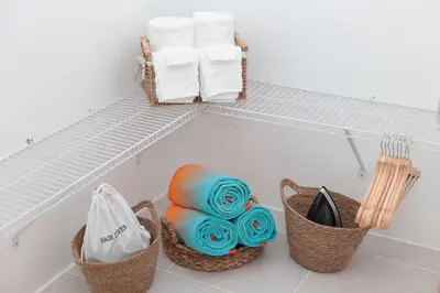 a bathroom with baskets and towels on a shelf at Rustic Charm, Apartment in the heart of Santiago in Santiago de los Caballeros