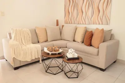 a living room with a couch and a table at Rustic Charm, Apartment in the heart of Santiago in Santiago de los Caballeros