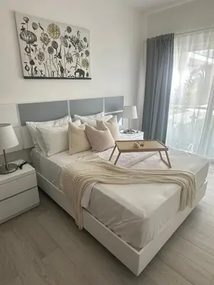 a bedroom with a bed with a table on it at Escape perfecto, punta cana in Punta Cana
