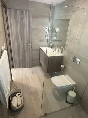 a bathroom with a toilet and a glass shower at Escape perfecto, punta cana in Punta Cana