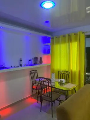 a dining room with a table and chairs and a yellow curtain at Mi Rinconcito in Colorado
