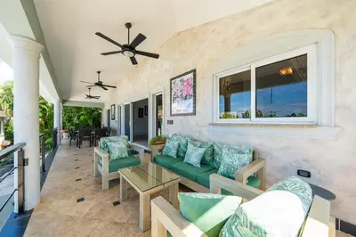 a living room with a couch and a table at 6BR, Jacuzzi, Ocean View, Solar Backup Power in Sosúa