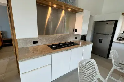 a kitchen with white cabinets and a stove top oven at 5 Bedroom Villa With BBQ and Washer in Las Terrenas