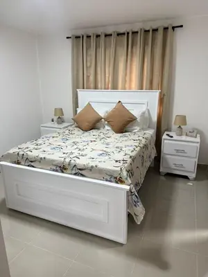 a bedroom with a large white bed with pillows at Luxurious Apartment in Santiago de los Caballeros