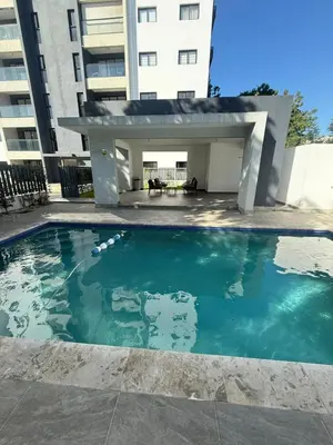a swimming pool in front of a building at Luxurious Apartment in Santiago de los Caballeros
