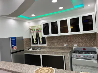 a kitchen with a sink and a stove at Moderna casa cerca del aeropuerto SDQ y de mi rent cars in La Caleta