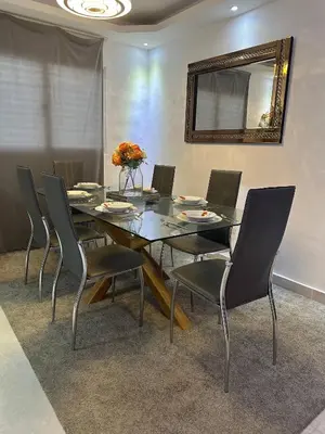 a dining room table with chairs and a mirror at Cozy Santo Domingo Apartment in San Isidro in Juan López