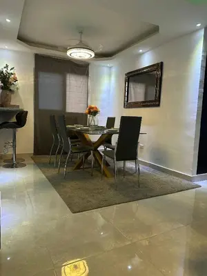 a dining room with a table and chairs at Cozy Santo Domingo Apartment in San Isidro in Juan López