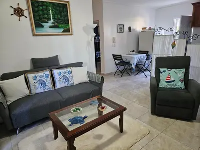 a living room with a couch and a table at Garden II in Boca Chica