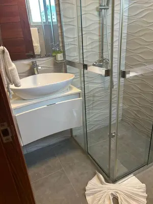 a bathroom with a sink and a glass shower at REFA - 404 · Luxury 1BR Suite in Piantini | Modern • Pool • Gym in Santo Domingo