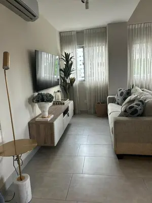 a living room with a couch and a table at REFA - 404 · Luxury 1BR Suite in Piantini | Modern • Pool • Gym in Santo Domingo