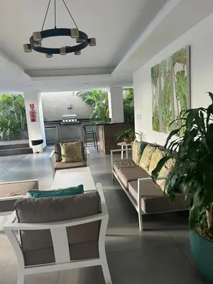a living room with couches and a chandelier at REFA - 404 · Luxury 1BR Suite in Piantini | Modern • Pool • Gym in Santo Domingo