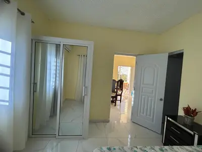 a bedroom with a walk in shower and a glass door at Apartamentos-Oliver in Las Galeras