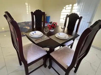 a black dining room table with four chairs and glasses at Apartamentos-Oliver in Las Galeras
