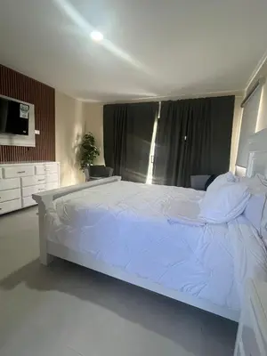 a bedroom with a large white bed in a room at Villa Medrano