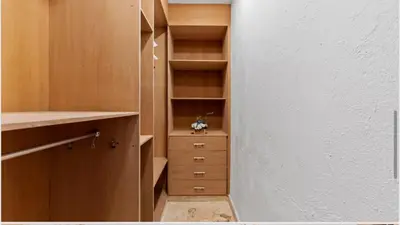 a walk in closet with wooden shelves and cabinets at Chic Villa Pool Casa de Campo in La Romana