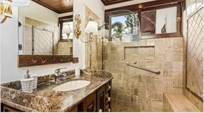 a bathroom with a sink and a large mirror at Chic Villa Pool Casa de Campo in La Romana