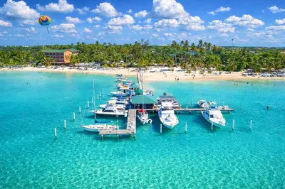 a group of boats docked at a dock in the water at Hotel Don Michele in Boca Chica