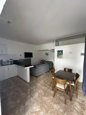 a kitchen and a dining room with a table and chairs at Residencial JG in Punta Cana