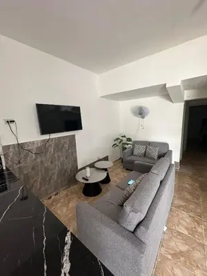 a living room with a couch and a flat screen tv at Residencial JG in Punta Cana