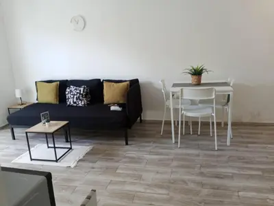a living room with a couch and a table at La belle planque de Punta Cana- Playa 10 minutos a pie in Punta Cana