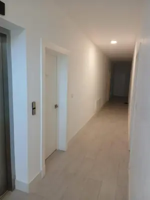 an empty hallway with white walls and a tile floor at La belle planque de Punta Cana- Playa 10 minutos a pie in Punta Cana