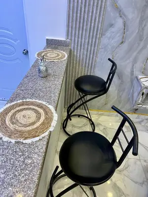 two black chairs sitting next to a counter at Moderna casa seca de aeropuerto SDQ y de mi rent cars in La Caleta