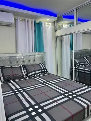 a bedroom with two beds and a large window at Moderna casa seca de aeropuerto SDQ y de mi rent cars in La Caleta