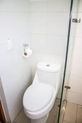 a bathroom with a toilet and a toilet paper roll at City Sea Exclusive Colonial Gem with Ocean View in Santo Domingo
