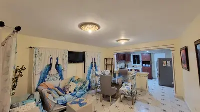 a living room with a couch and a table at Descansa sin prisas a minutos del Aeropuerto in La Caleta